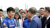 South Korean president Moon Jae-in exchanges with head coach of the Vietnamese national football team Park Hang- seo and players of the team
