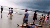 Four killed when big waves sweep 11 people out to sea