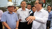 HCMC party chief Nguyen Thien Nhan and city People’s Committee deputy chairman Le Van Khoa survey the pump system installation area in Nguyen Huu Canh street on July 12 (Photo: SGGP)
