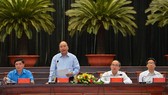 PM Nguyen Xuan Phuc (standing) at the meeting with highly-skilled workers in HCMC. (Photo: VNA)