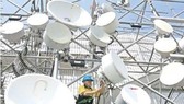 A technician carries out maintenance work at one of Indosat Ooredoo's base transceiver stations (BTS) in Jakarta. (Source: Jakarta Post)