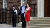 Britain’s Prince William and Kate, Duchess of Cambridge wave holding their newborn baby son. — AFP Photo