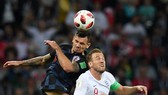 Dejan Lovren tranh bóng với Harry Kane (phải, Anh)