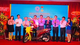 Ban lãnh đạo Công ty Yến Sào Khánh Hoà trao thưởng cho khách hàng trúng thưởng xe máy Honda SH Mode. Ảnh: HỒNG MINH