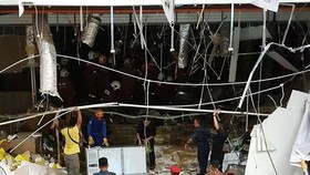 Malaysian security personnel inspect the site after an explosion at the City One Megamall in Kuching, the capital city of Sarawak state, on December 4 (Source: AFP)