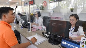 Công tác cấp giấy chứng nhận cho người dân đang gặp vướng mắc, cần đẩy mạnh việc ủy quyền để tháo gỡ, tạo thuận lợi cho người dân. Ảnh: VIỆT DŨNG