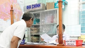 Người dân đang làm thủ tục nhà đất tại UBND phường Phước Long B, quận 9. Ảnh: KIỀU PHONG