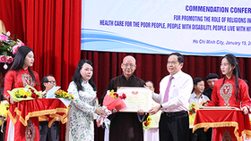 Chairman Ma and Health Minister Tien give certificates of merit to teams and individuals that well contributed to the charitable activities to take care of poor people (Photo: SGGP)