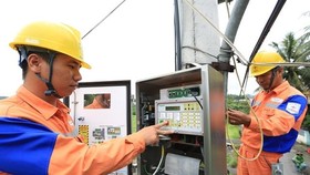 Workers of Quang Ninh Electricity Company under the Northern Power Corporation install data transmission equipment. — VNA/VNS Photo
