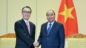 Vietnamese Prime Minister Nguyen Xuan Phuc (R) and Kanetsugu Mike, Executive President of Mitsubishi UFJ Financial Group (MUFG) Bank