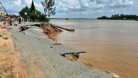 A 35 m- long section of National Highway 91 suddenly cracked and fell into the Hau River