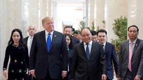 US President Donald Trump is welcomed by PM Nguyen Xuan Phuc at the Government Office where the two leaders had lunch together. (Photo: Sggp)