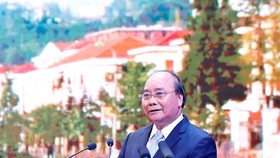 Prime Minister Nguyen Xuan Phuc delivers a speech at the trade, investment and tourism promotion conference of Lao Cai province on July 20 (Photo: VNA)