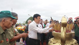 Đồng chí Trương Tấn Sang thắp hương tưởng niệm các liệt sĩ. Ảnh: VĨNH THUẬN