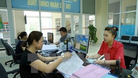 Nâng cao chất lượng công tác tuyên truyền, hỗ trợ người nộp thuế. (Ảnh: Hoàng Hùng/TTXVN)