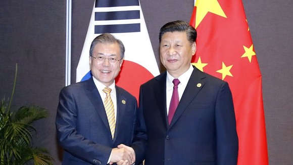 South Korean President Moon Jae-in (L) shakes hands with Chinese President Xi Jinping before their talks in Papua New Guinea on the sidelines of the Asia Pacific Economic Cooperation (APEC) forum on Nov. 17, 2018. (Yonhap)