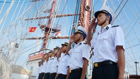 Crew members of the Le Quy Don sailing ship make salute when the ship reaches Changi port. (Photo: qdnd.vn)