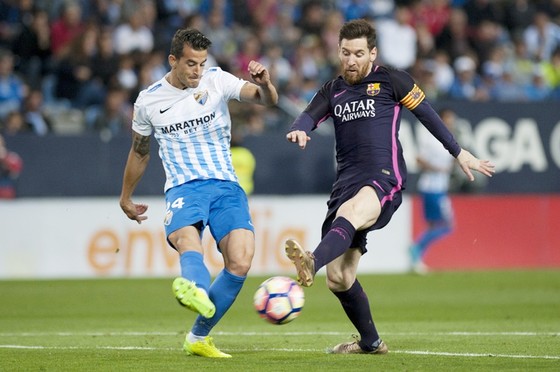 Messi (phải) và đồng đội không khó để giành chiến thắng trước Malaga. Ảnh: Getty Images