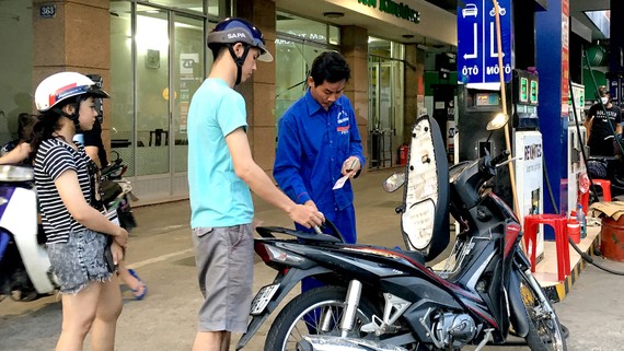 Đổ xăng tại cây xăng trên đường Nguyễn Thị Thập chiều 16-5. Ảnh: CAO THĂNG