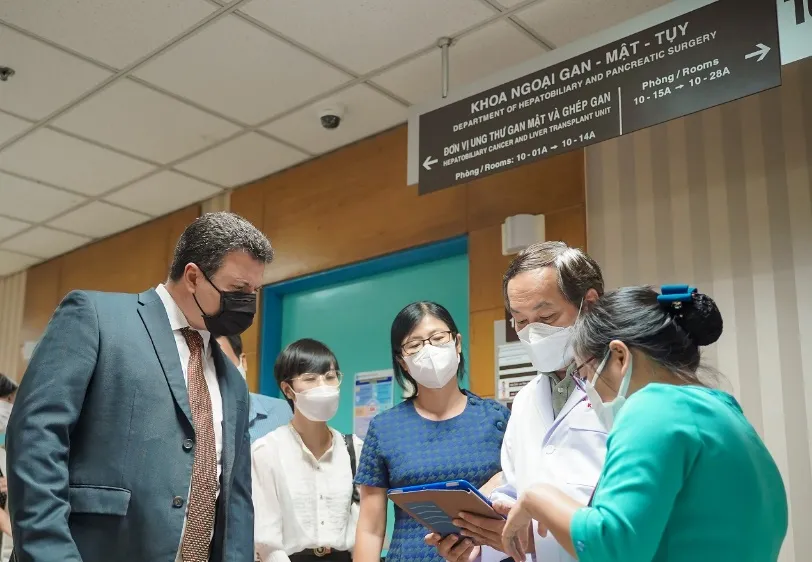 Ông Lennor Carrillo (trái), Tổng giám đốc Roche Pharma Việt Nam, trao đổi với bác sĩ Bệnh viện Đại học Y Dược TPHCM