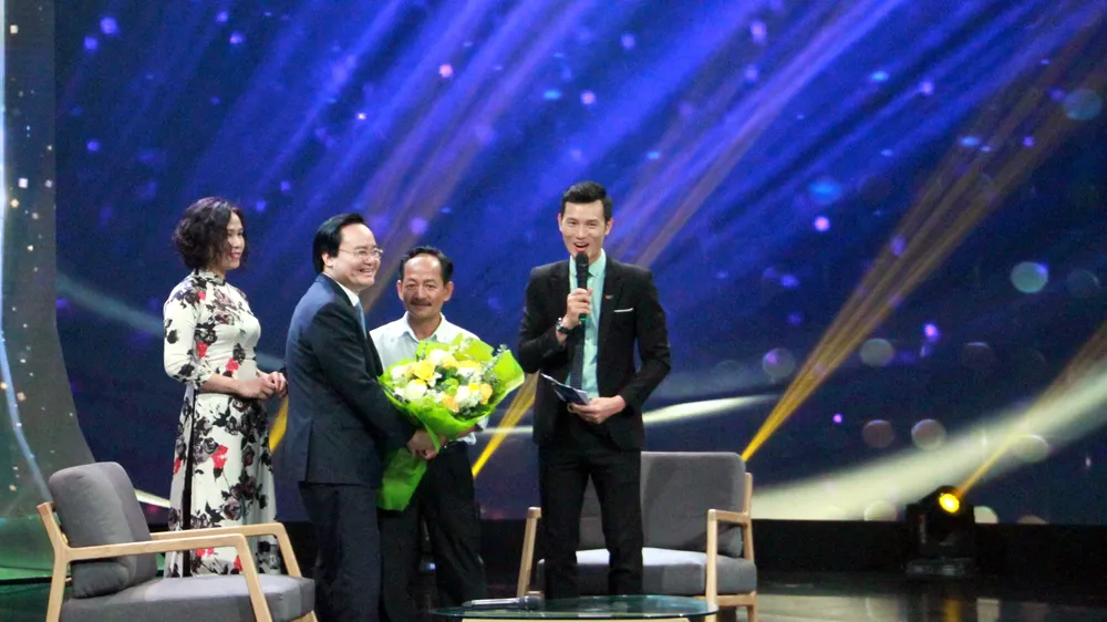 Bộ trưởng Bộ GD-ĐT Phùng Xuân Nhạ tặng hoa cho thầy Lưu Văn Hóa