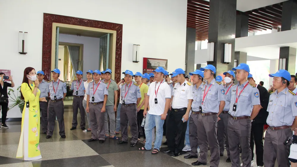 Đoàn cán bộ, thủy thủ tài kiểm ngư KN 290 nghe hướng dẫn viên giới thiệu về Dinh Thống Nhất. Ảnh: TRẦN YÊN