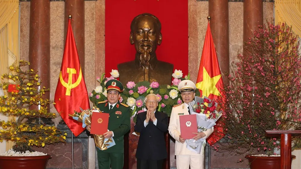 Tổng Bí thư, Chủ tịch nước Nguyễn Phú Trọng trao quyết định phong quân hàm Đại tướng và tặng hoa chúc mừng các đồng chí Tô Lâm, Lương Cường. Ảnh TTXVN