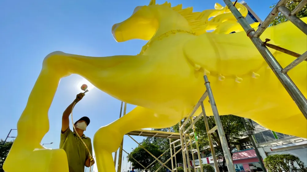 Công nhân phun sơn, hoàn thiện tạo hình các tượng ngựa tại khu vực phía sông Bạch Đằng, thuộc Đường hoa Nguyễn Huệ xuân Bính Ngọ 2026. Ảnh: HOÀNG HÙNG
