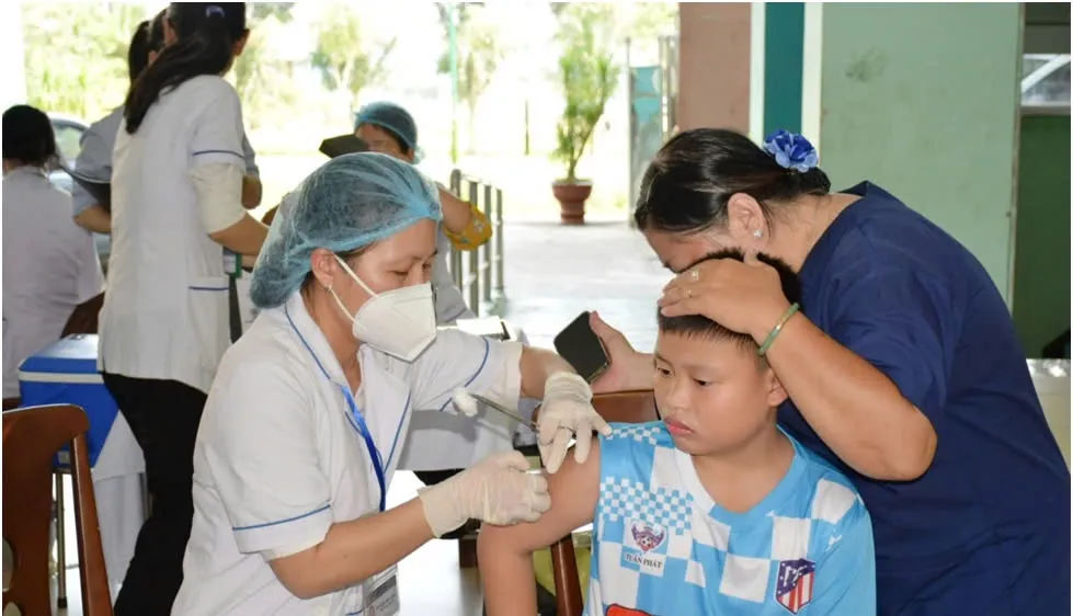 Nhân viên y tế tiêm vaccine cho trẻ