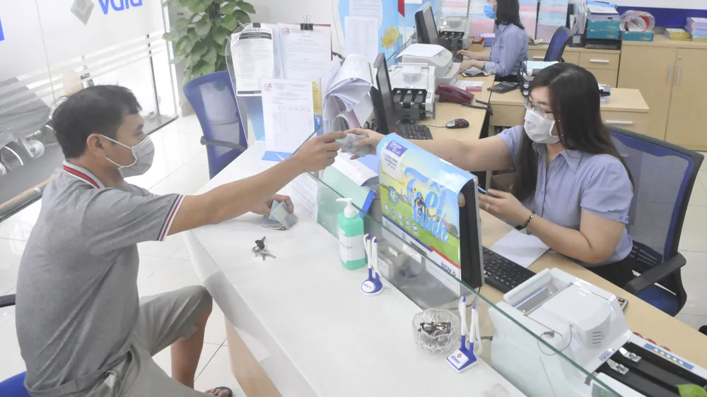 Khách hàng giao dịch tại chi nhánh BIDV Nam Kỳ Khởi Nghĩa chiều 13-4-2020. Ảnh: Cao Thăng