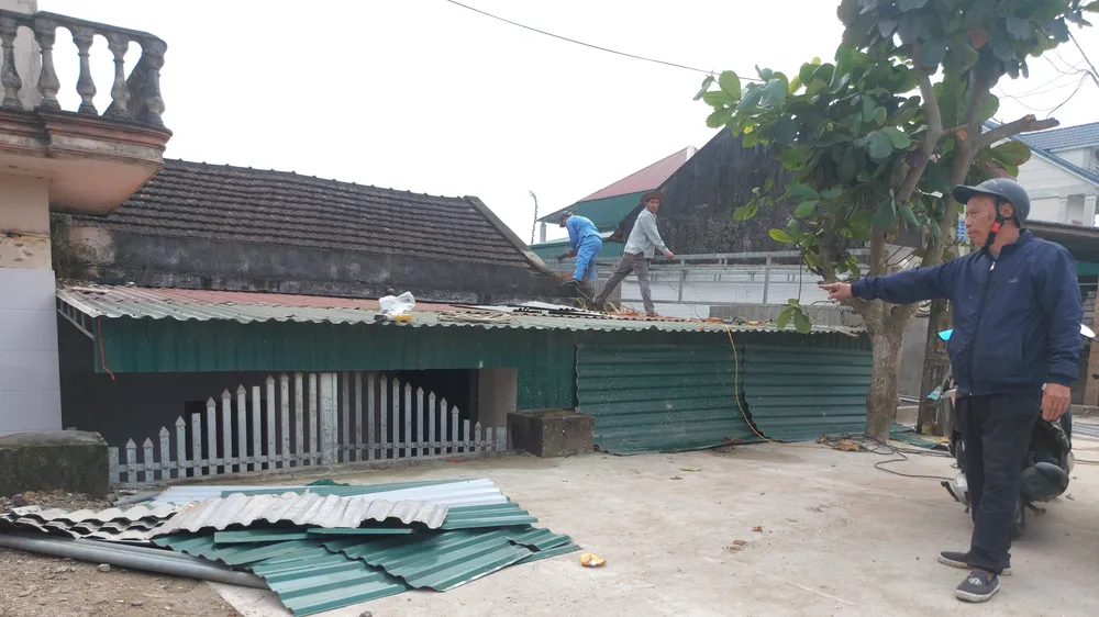Ông Phan Đình Ngọc (thôn Tân Tiến, xã Phú Lộc) bên cổng nhà bị bịt kín sau khi nâng đường phía trước. Ảnh chụp ngày 2-2-2023