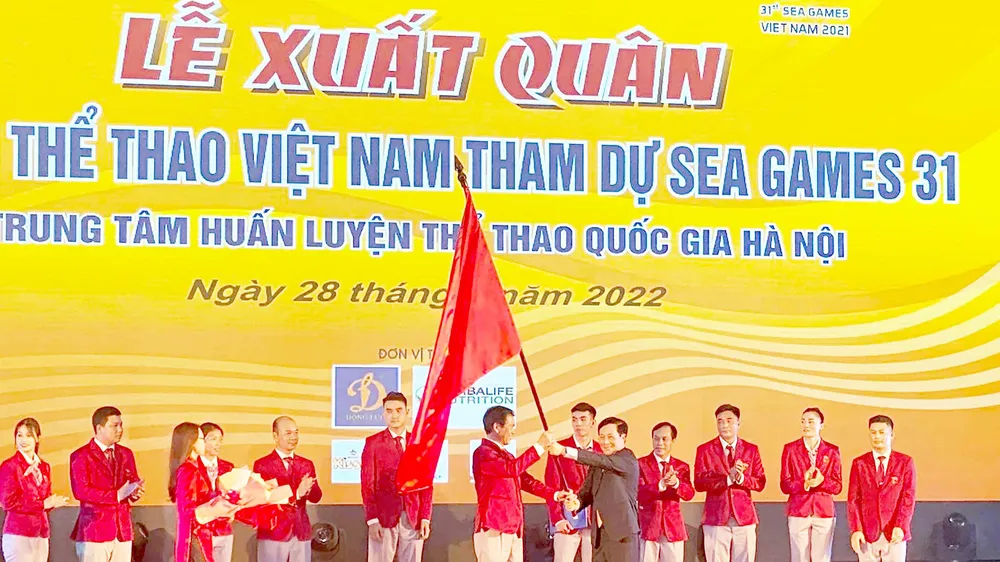 Phó Thủ tướng Thường trực Phạm Bình Minh trao lá quốc kỳ cho Trưởng đoàn Thể thao Việt Nam Trần Đức Phấn. Ảnh: MINH CHIẾN