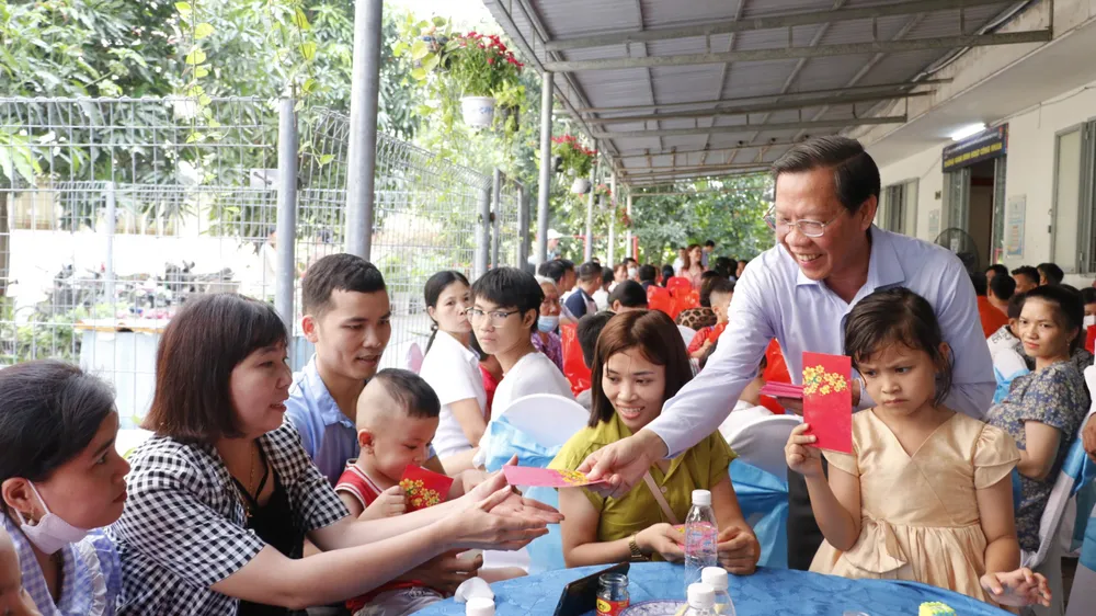 Chủ tịch UBND TPHCM Phan Văn Mãi lì xì công nhân không về quê ăn tết tại khu lưu trú công nhân, Khu Công nghiệp Hiệp Phước, huyện Nhà Bè. Ảnh: NGÔ BÌNH