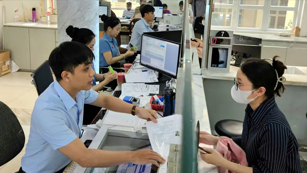 ông chức Trung tâm Phục vụ hành chính công phường Sài Gòn, TPHCM tiếp nhận, giải quyết hồ sơ cho người dân. Ảnh: NGÔ BÌNH