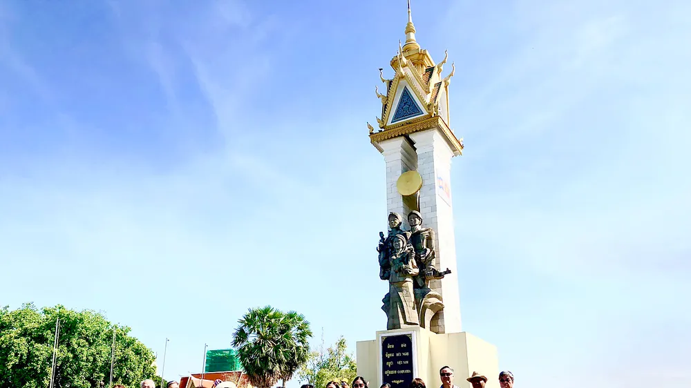 Các cựu sinh viên khóa 14 Khoa Ngữ văn, Đại học Tổng hợp Hà Nội chụp hình lưu niệm trước Tượng đài Quân tình nguyện Việt Nam ở Campuchia