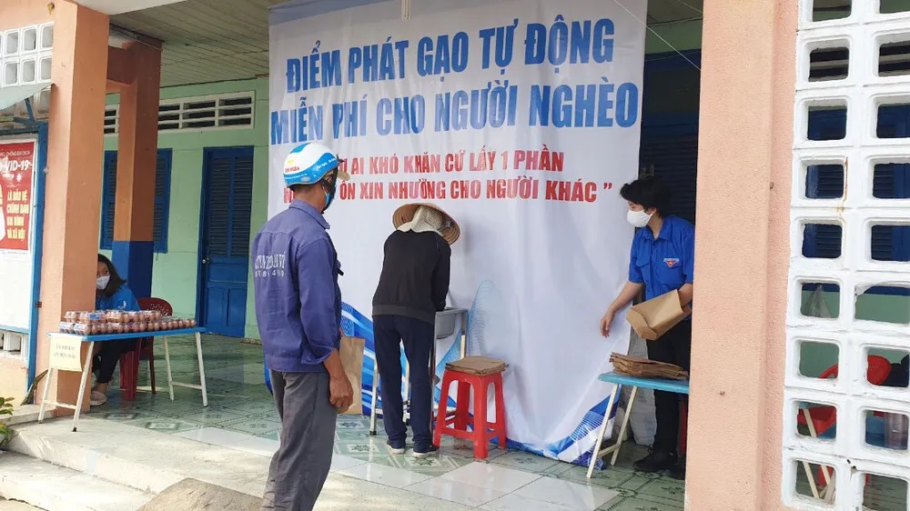 Người dân nhận gạo từ "ATM gạo" tại phường Tân Thới Nhất 