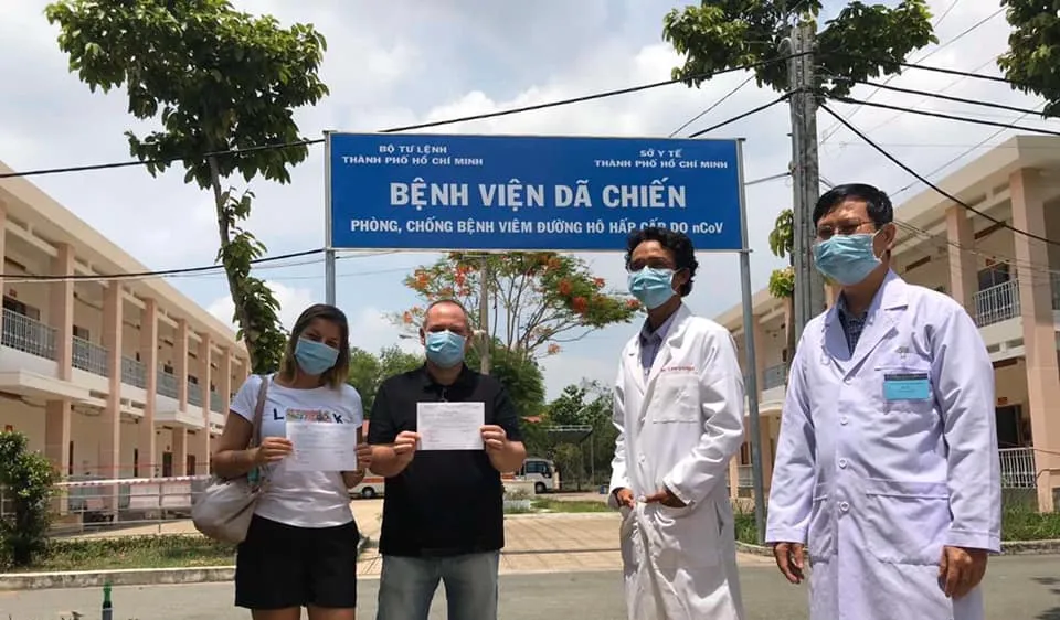 Hai bệnh nhân được điều trị khỏi Covid-19 xuất viện tại Bệnh viện bệnh lý hô hấp cấp tính Củ Chi trong sáng 18-4. Ảnh: TTXVN