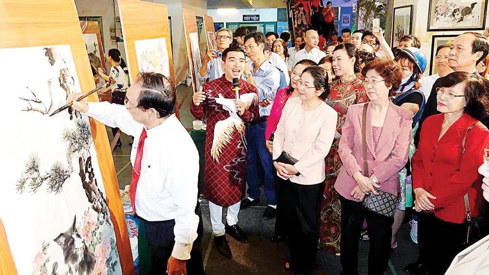 Lãnh đạo TPHCM thưởng lãm vẽ tranh thủy mặc tại lễ hội. Ảnh: DŨNG PHƯƠNG