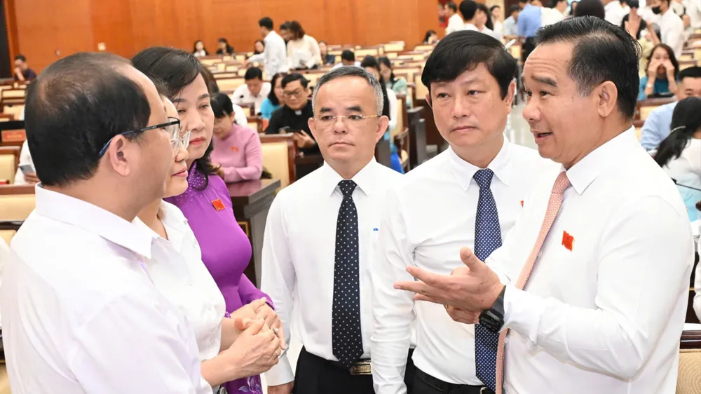 Các đồng chí lãnh đạo TPHCM và các đại biểu trao đổi tại kỳ họp thứ 4 HĐND TPHCM khóa XI