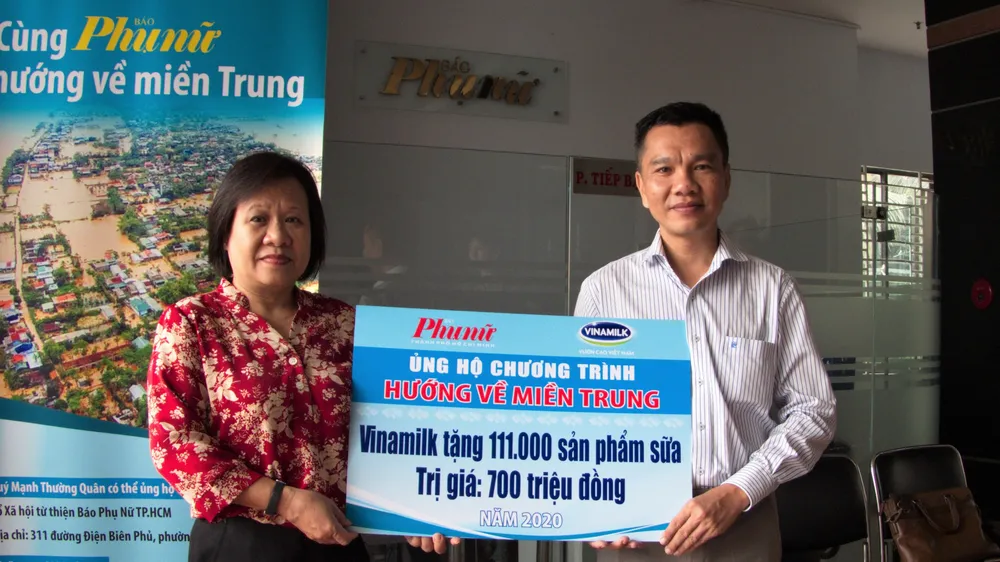 Ông Nguyễn Trung, Chủ tịch Công đoàn Công ty Vinamilk trao bảng tượng trưng 111.000 sản phẩm dinh dưỡng ủng hộ đồng bào miền Trung