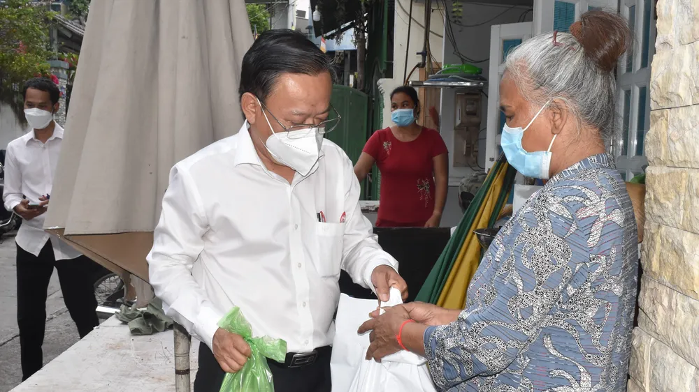 Trưởng Ban Dân vận Thành ủy TPHCM Nguyễn Hữu Hiệp tặng quà một số hộ dân đồng bào dân tộc có hoàn cảnh khó khăn ở quận Tân Bình. Ảnh: ĐÌNH LÝ