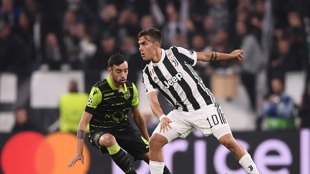 Paulo Dybala (phải, Juventus) đi bóng qua hàng thủ Sporting. Ảnh: Getty Images.