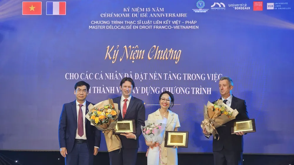 TS Lê Trường Sơn, Hiệu trưởng (ULAW) trao tặng Kỷ niệm chương cho GS-TS Erik Van Den Haute, GS-TS Mai Hồng Quỳ, GS-TS Laurent Grosclaude - những cá nhân đặt nền tảng trong việc hình thành và xây dựng chương trình đào tạo.