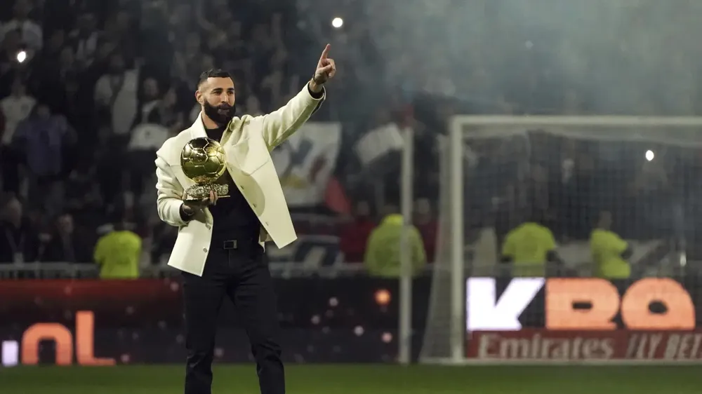 Karim Benzema ăn mừng danh hiệu Quả bóng Vàng tại sân vận động Groupama cùng khán giả Olympique Lyon hồi năm 2022. Ảnh: AP