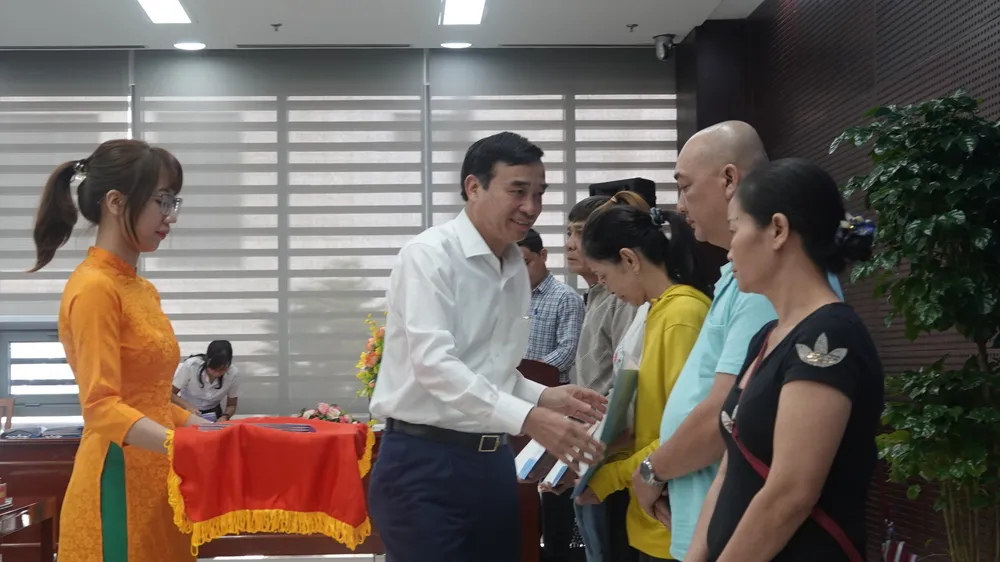 Ông Lê Trung Chinh, Chủ tịch UBND TP Đà Nẵng trao quyết định cho các hộ nghèo có hoàn cảnh đặc biệt khó khăn. Ảnh: XUÂN QUỲNH