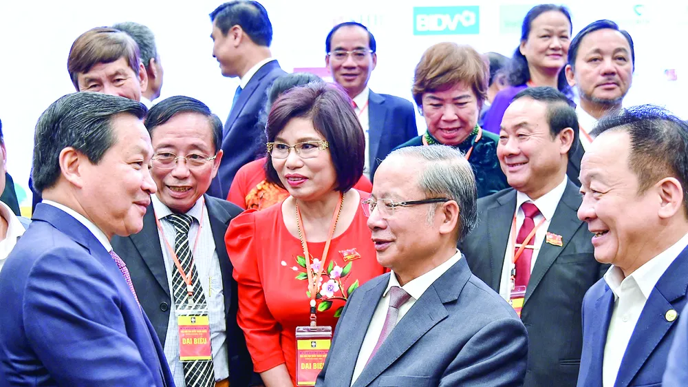 Phó Thủ tướng Lê Minh Khái (bìa trái) trao đổi với các đại biểu dự đại hội. Ảnh: VIẾT CHUNG