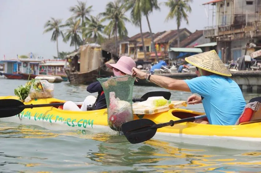 Hai du khách tham gia tour vớt rác trên sông Hoài (TP Hội An, tỉnh Quảng Nam)