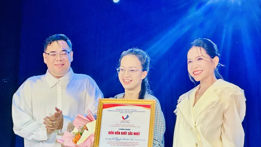 NSƯT - Đạo diễn Lê Nguyên Đạt, Phó Hiệu trưởng Trường Đại học Sân khấu - Điện ảnh TPHCM và diễn viên Khả Như trao giải Diễn viên xuất sắc cho sinh viên Lê Nguyễn Minh Anh. Ảnh: THANH HIỆP