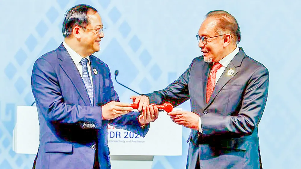 Thủ tướng Malaysia Anwar Ibrahim (phải) tiếp nhận chức Chủ tịch luân phiên ASEAN từ Thủ tướng Lào Sonexay Siphandone. Ảnh: BERNAMA