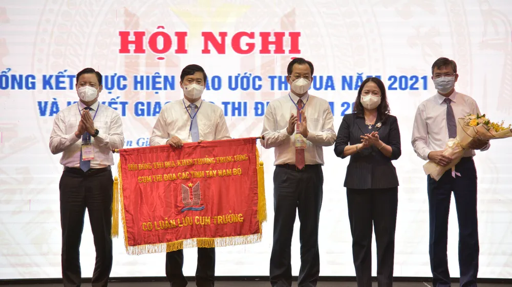 Đại diện lãnh đạo tỉnh Kiên Giang trao cờ cụm trưởng cho lãnh đạo tỉnh Đồng Tháp. Ảnh: QUỐC BÌNH